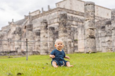 Bebek gezgini, Chichen Itza olarak bilinen Maya mimarisinin eski piramidini ve tapınağını izleyen turistler. Bunlar eski Kolombiya öncesi medeniyetin kalıntıları.