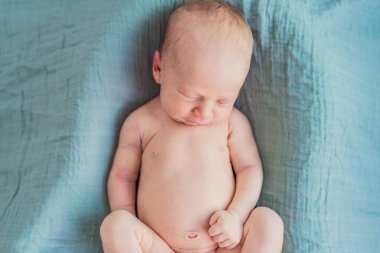 Bebek rahat yuvasında huzur içinde uyuyor. Yeni doğan fotoğraf çekimi, ilk zamanların dingin masumiyetini ve sıcaklığını yakalar..