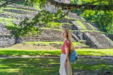 Palenque, Meksika 'nın antik piramitlerini keşfeden kadın turist, sık ormanlarla çevrili. Kültür mirası ve macera yolculuğu konsepti.
