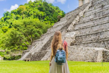 Palenque, Meksika 'nın antik piramitlerini keşfeden kadın turist, sık ormanlarla çevrili. Kültür mirası ve macera yolculuğu konsepti.