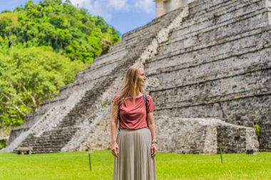 Palenque, Meksika 'nın antik piramitlerini keşfeden kadın turist, sık ormanlarla çevrili. Kültür mirası ve macera yolculuğu konsepti.