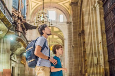 Father and his son tourists exploring the Metropolitan Cathedral in Mexico City. Woman admiring the architecture and history of Mexicos iconic landmark. Concept of cultural heritage, religious clipart