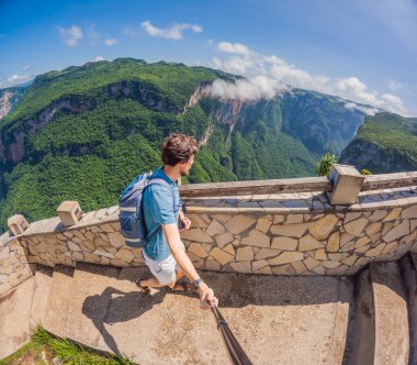 Male tourist exploring Sumidero Canyon National Park, Mexico. Adventurous traveler enjoying breathtaking views of cliffs and river in this iconic natural landmark. Concept of nature, exploration, and clipart