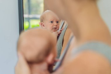 Bir anne sevgiyle yeni doğmuş bebeğini kucaklar, onları göğsüne yakın tutar. Yumuşak bir sıcaklık, güven ve derin anne sevgisi. Bağlanmayı, rahatlığı ve kırılmaz bağı sembolize ediyor.
