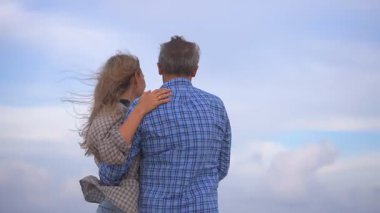 Romantik orta yaşlı çift kumsalda huzurlu bir akşamın tadını çıkarıyor. Olgun ilişkiler ve yavaş yaşam tarzı için aşk, bağlantı ve birliktelik kavramı