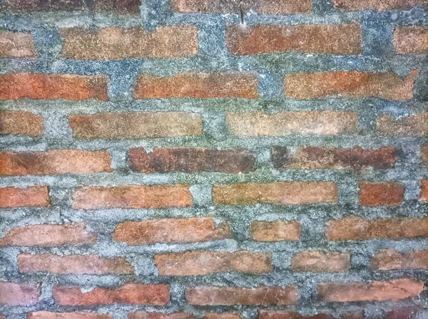 the walls of the house are made of red brick