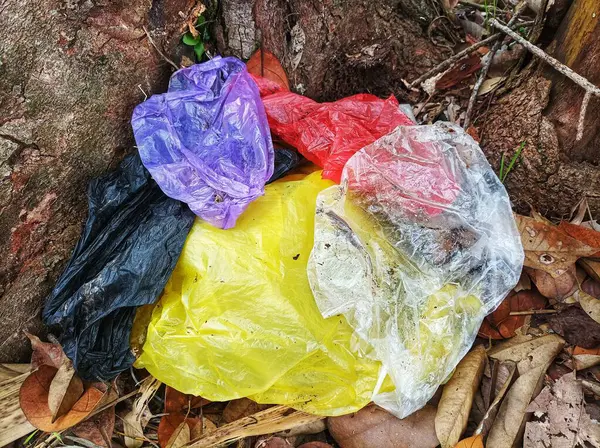 stock image Various colored plastic bags were collected under the tree