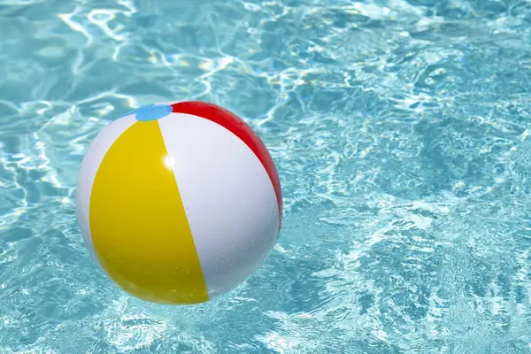Summer vacation. Beach ball. Summer party. Inflatable beach ball. Striped ball for play in water. Copy space for text