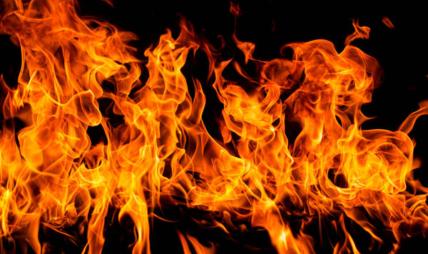 Огонь и пламя на заднем плане. Яркий пламенный фон. Текстура огня на черном фоне. Горящий красный огонь. Большой пожар ночью