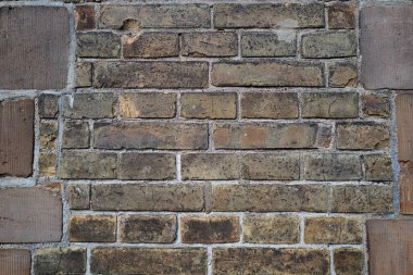Duvarın arkasında tuğla var. Tuğla duvarın desenli arka planı. Arka plan için duvar deseni. Duvar grunge arkaplanı