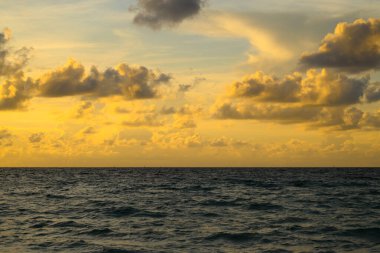 Deniz yüzü arka planı. Kara fırtınalı, dramatik bulutlu gökyüzü. Dramatik gökyüzü ile gün batımı deniz manzarası. Bulutlu gökyüzü
