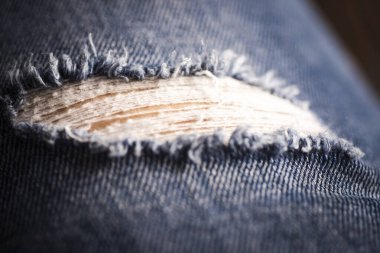 Kot pantolonu yırtılmış. Kot pantolon moda geçmişi. Mavi kot kumaş dokusu arka planı. Denim kot kumaşı. Tasarım için Denim arkaplan dokusu