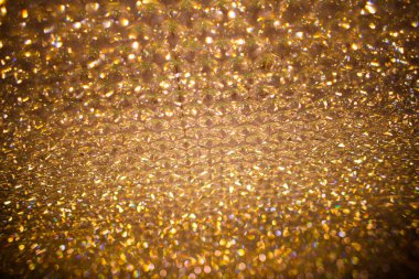 Tatil geçmişleri. Altın rengi parlak arka plan bulanık. Bokeh parlak arka plan. Altın bokeh. Altın parıltılı bokeh arka plan. Kopyalama alanı olan soyut arkaplan. Tatil geçmişleri