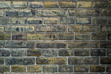 Tuğla duvarın arka planı. Tuğla duvar cepheli bir mimari geçmişi var. Taş kaplama duvar arkaplanı. Poster ya da afiş için tuğla yüzey arka planı. Duvarcılık Tuğlası
