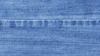 Kumaşlı arka plan için kot pantolon deseni. Denim kot kumaşı. Kot pantolonun denim dokusu. Reklam için boş alan. Sancak arkaplanı