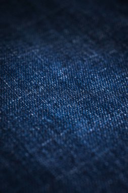 Kotun kumaş dokusu. Mavi kot pantolon arka planı. Kot pantolon ya da kot pantolon. Cepleri, perçinleri, düğmeleri, dikişleri olan kotlar.