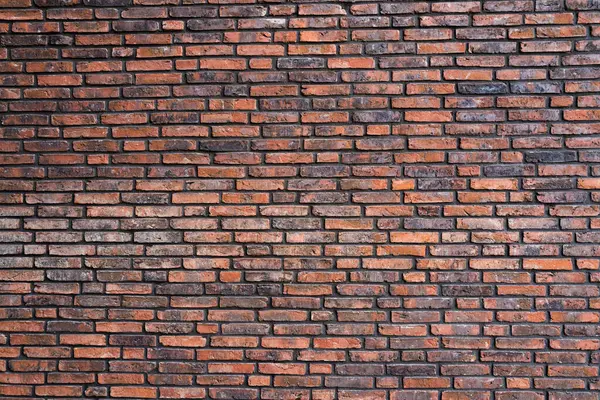Duvarın arkasında tuğla var. Tuğla duvarın desenli arka planı. Arka plan için duvar deseni. Arkaplan için tuğla duvar dokusu. Tuğla yüzeyi