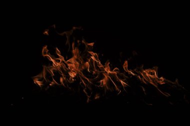 Yangın arka plan kıvılcımları. Soyut alevler arka planı. Yanan ateş. Siyah arka planda ateş dokusu. Reklam için kopyalama alanı olan alevi ateşle