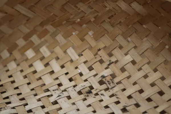 a close up of a woven basket with a black spot
