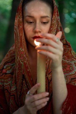    Mumlu kadın ormanda dua ediyor. 