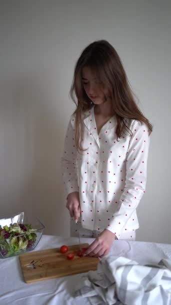 Teenage Girl Pajamas Prepares Fresh Salad Greens Tomatoes — Stock Video