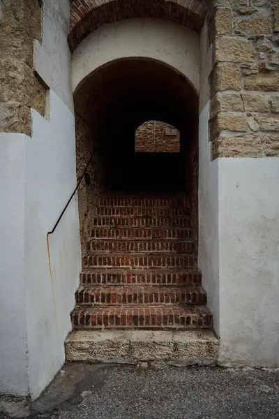 arch with stairs in the wall of a stone house