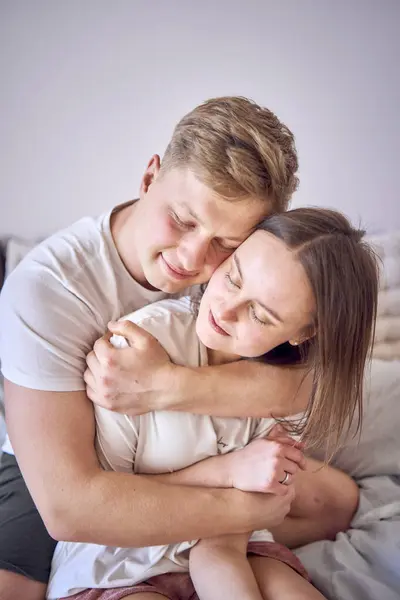 stock image  man hugs his wife from behind, face to face                     