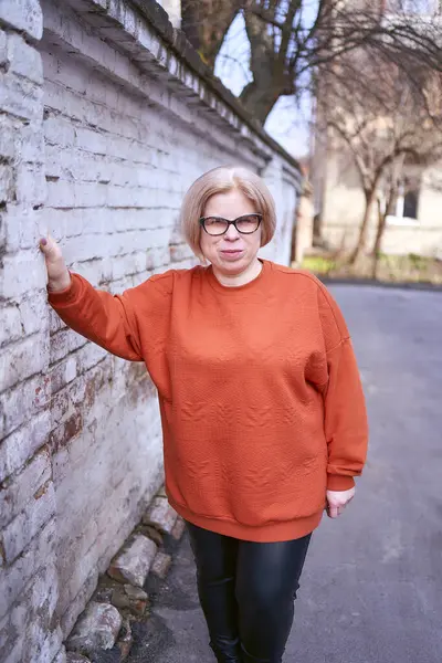 春天的一天 穿着橙色毛衣和皮裤的残疾妇女的肖像 — 图库照片