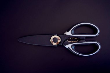 a kitchen scissors in a protective case on a black background clipart