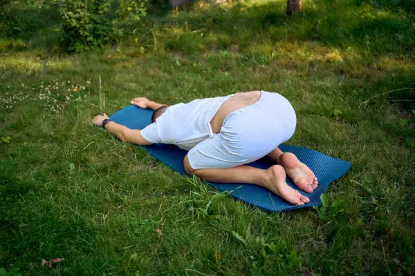 stock image  man performs somatic exercises in the garden in the morning