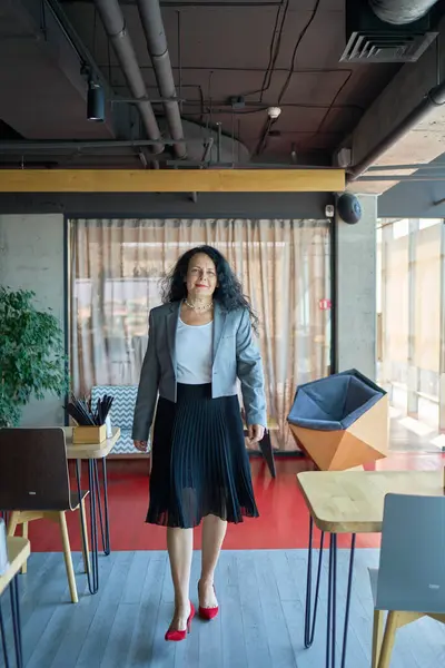 stock image 60s stylish, confident mature businesswoman, female leader, middle older aged company ceo director, experienced senior female professional, business coach team leader in modern office.