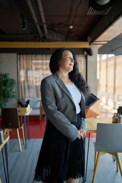 stock image 60s stylish, confident mature businesswoman, female leader, middle older aged company ceo director, experienced senior female professional, business coach team leader in modern office.