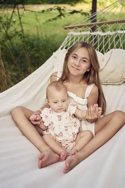 stock image sisters, pre-teen and baby on the  picnic