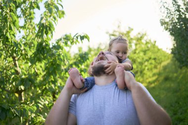  Babam omuzlarında bir bebekle oynuyor.                       