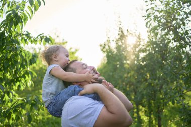  Babam omuzlarında bir bebekle oynuyor.                       