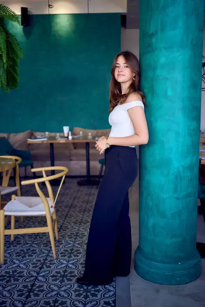 stock image       16-year-old teenage girl in old money style clothes in  fancy restaurant                         