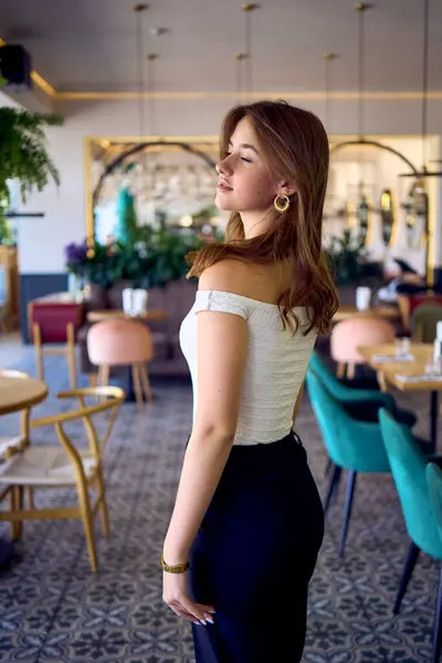 stock image                  16-year-old teenage girl in old money style clothes in  fancy restaurant                         