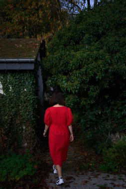       30 yaşında, orta boylu, sonbahar bahçesinde kırmızı çarşaf giymiş bir kadın.                        