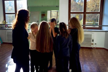 group of pre-teens perform a teacher's task during an acting class, detective game, investigation                         clipart