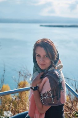 young woman in scarf Sevanavank, monastery on lake Sevan, armenia clipart