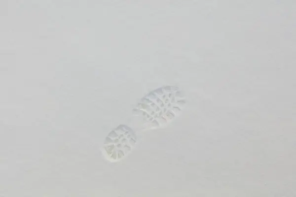 Closeup of footprint in fresh snow in winter.