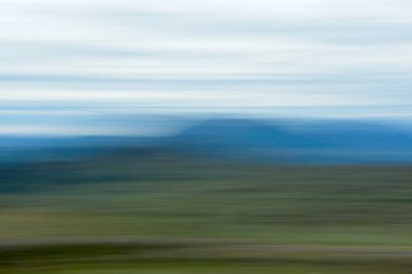 ICM intentional camera movement view of Saana fell in Finland in the summer from Storfjord, Norway. clipart