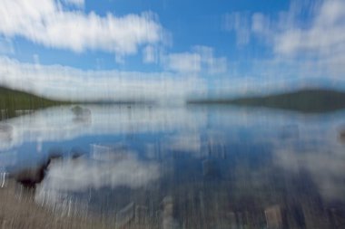 Intentional camera movement (ICM) of lake Kilpisjrvi in cloudy summer weather, Enonteki, Lapland, Finland. clipart