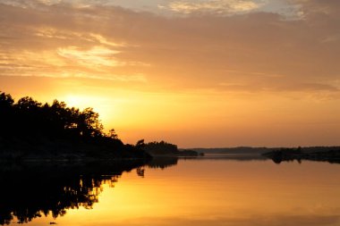 Yazın Birskar adasında gün batımında gökyüzünde bulutlar, Parainen, Finlandiya.