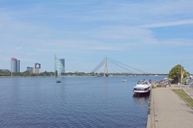 Riga, Latvia - June 21, 2019: River cruise boat on Daugava river pier in Riga in summer.