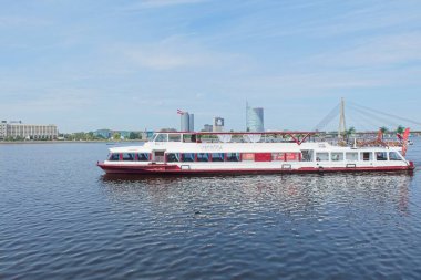 Riga, Latvia - June 21, 2019: River cruise boat on Daugava river in Riga in summer.