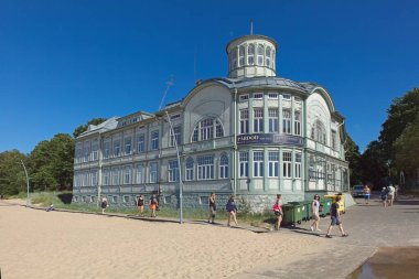 Jurmala, Latvia  June 22, 2019: Former bath house at Jurmala beach in sunny summer  weather. clipart