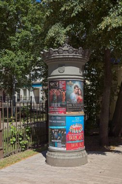 Riga, Latvia - June 23, 2019: Round advertising column in Old Town of Riga.