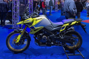 Pasila, Helsinki, Finland - 2.3.2024: Suzuki V-Strom 1050 DE motorcycle on display at MP 24 Motorcycle fair at Messukeskus Helsinki (Expo and Convention Centre).
