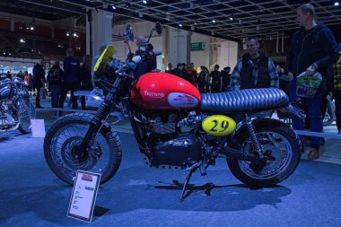 Pasila, Helsinki, Finland - 2.3.2024:  Custom Bike Trumph Scrambler motorcycle on display at MP 24 Motorcycle fair at Messukeskus Helsinki (Expo and Convention Centre).